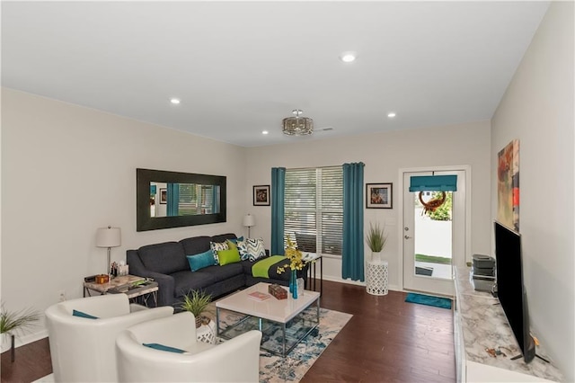 living area featuring baseboards, dark wood-type flooring, and recessed lighting