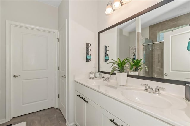 bathroom featuring a sink, a shower stall, and double vanity