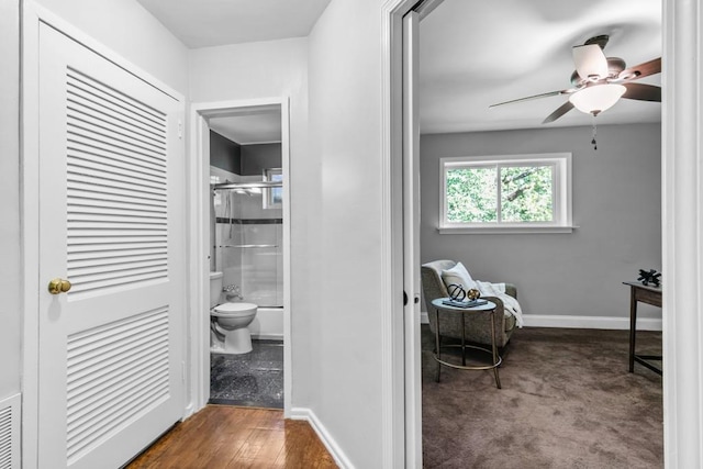 bathroom featuring shower / bath combination with glass door, wood-type flooring, ceiling fan, and toilet