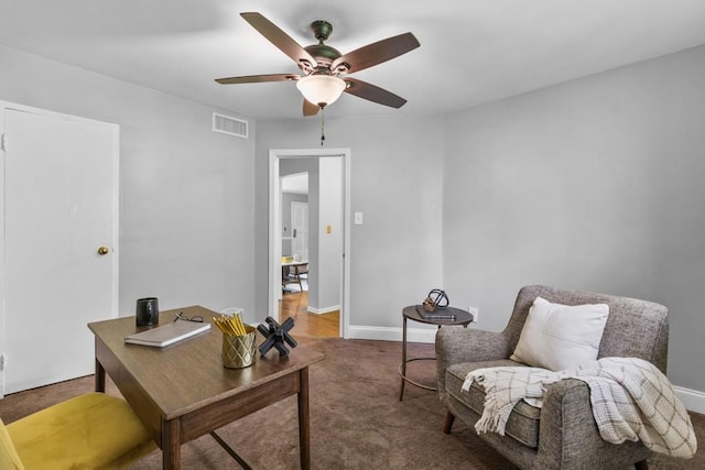 office space with ceiling fan and dark carpet