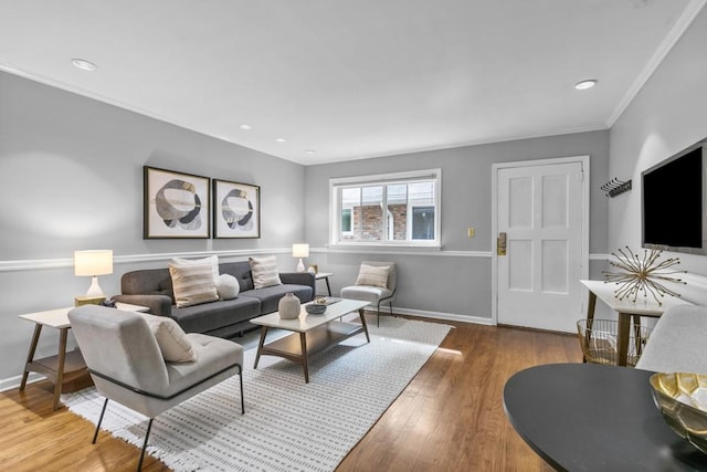 living room with crown molding and hardwood / wood-style floors