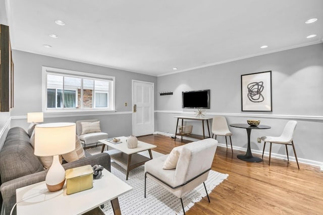 living room with crown molding and light hardwood / wood-style flooring