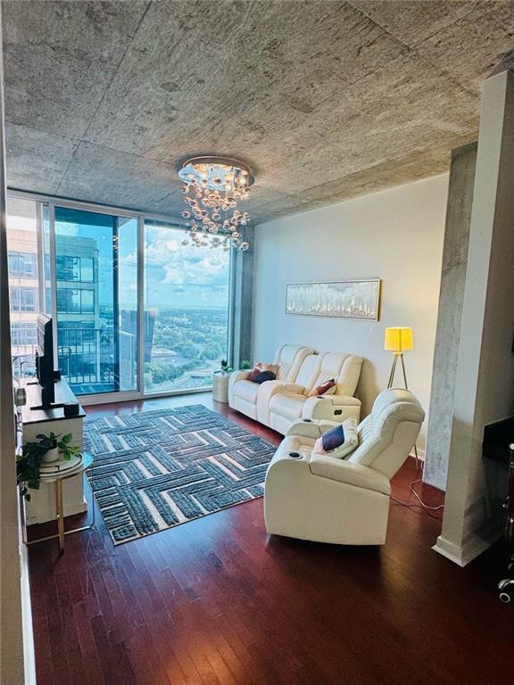 400 W Peachtree St NW Unit 3412, Atlanta, GA 30308 - living room featuring wood finished floors, a wall of windows, and a chandelier