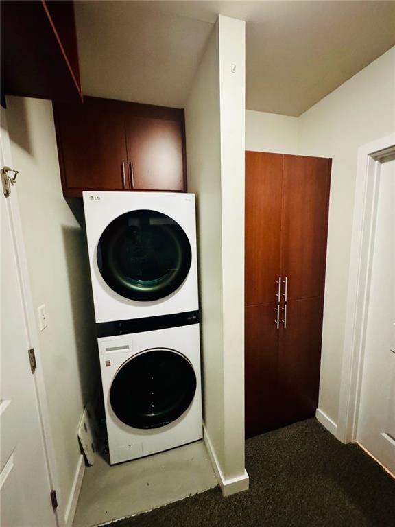 400 W Peachtree St NW Unit 3412, Atlanta, GA 30308 - laundry room featuring stacked washer / dryer and carpet floors