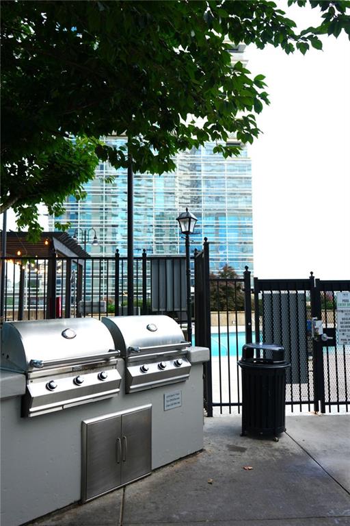 400 W Peachtree St NW Unit 3412, Atlanta, GA 30308 - view of patio / terrace with a community pool and exterior kitchen