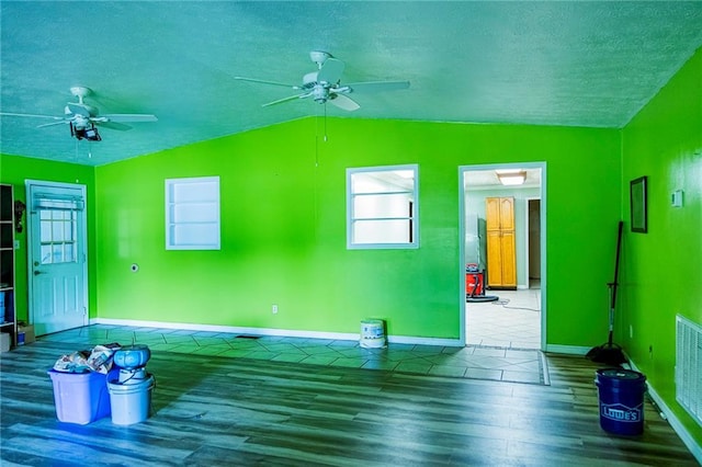 83 Manning Lake Rd, Rome, GA 30165 - unfurnished living room with a ceiling fan, wood finished floors, lofted ceiling, and a textured ceiling
