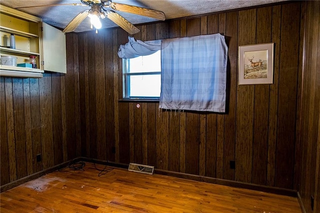 83 Manning Lake Rd, Rome, GA 30165 - empty room featuring ceiling fan, wooden walls, and wood finished floors