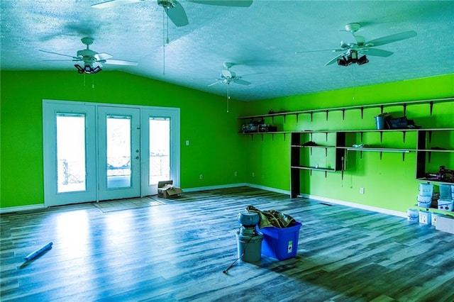 83 Manning Lake Rd, Rome, GA 30165 - unfurnished living room with wood finished floors, vaulted ceiling, ceiling fan, a textured ceiling, and french doors