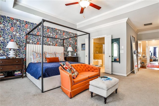 carpeted bedroom featuring visible vents, ornamental molding, baseboards, ensuite bathroom, and ceiling fan