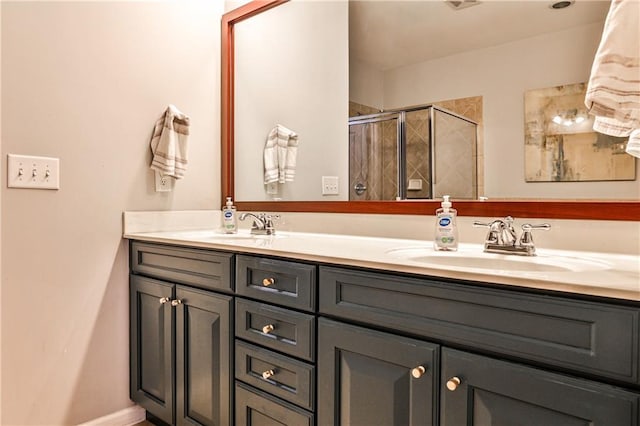 bathroom with double vanity, a sink, and a stall shower
