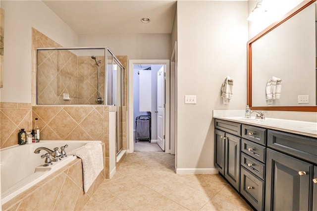 bathroom featuring vanity, baseboards, a bath, tile patterned floors, and a stall shower