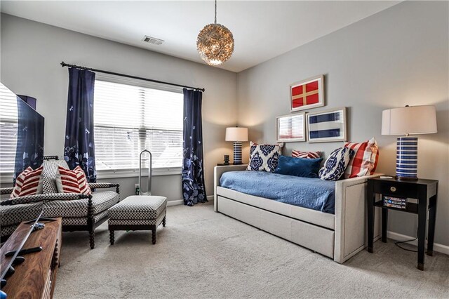 carpeted bedroom with baseboards and visible vents
