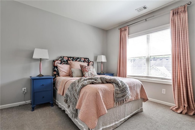 bedroom featuring visible vents, carpet floors, and multiple windows