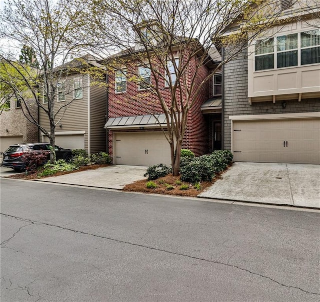 view of front of home with a garage, driveway, and brick siding