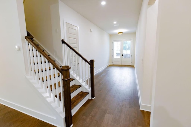 stairway featuring recessed lighting, wood finished floors, visible vents, baseboards, and french doors