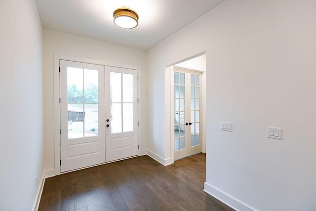 doorway to outside featuring baseboards, dark wood-style flooring, and french doors