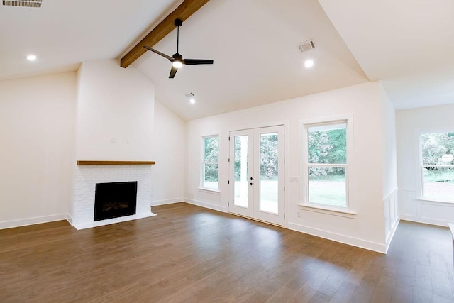 unfurnished living room featuring visible vents, ceiling fan, dark wood-style flooring, beamed ceiling, and a brick fireplace