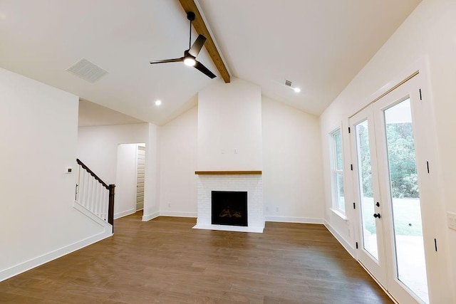 unfurnished living room with wood finished floors, visible vents, baseboards, stairs, and beamed ceiling