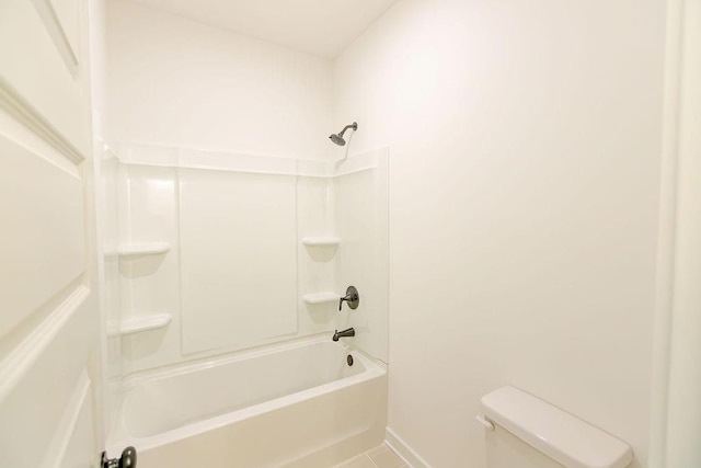 full bath featuring shower / washtub combination, tile patterned flooring, baseboards, and toilet