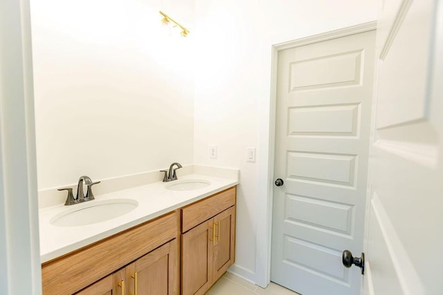 bathroom with tile patterned floors, a sink, and double vanity