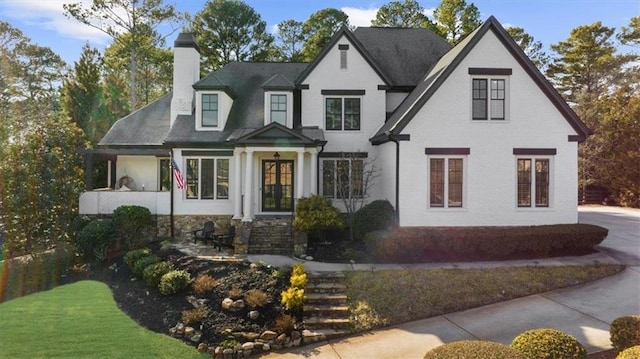 view of front of home with brick siding and a chimney