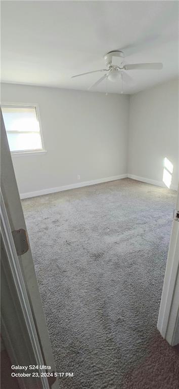 empty room with carpet floors and ceiling fan