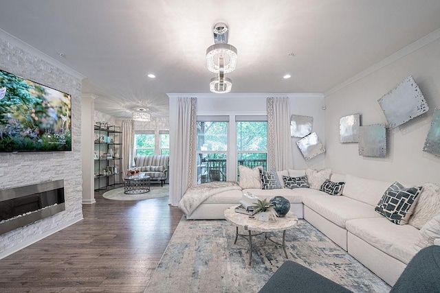 living area featuring a fireplace, recessed lighting, wood finished floors, and ornamental molding