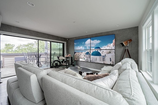 living area with wood finished floors and a healthy amount of sunlight