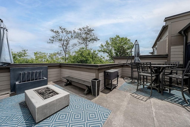 view of patio / terrace with outdoor dining area and an outdoor fire pit