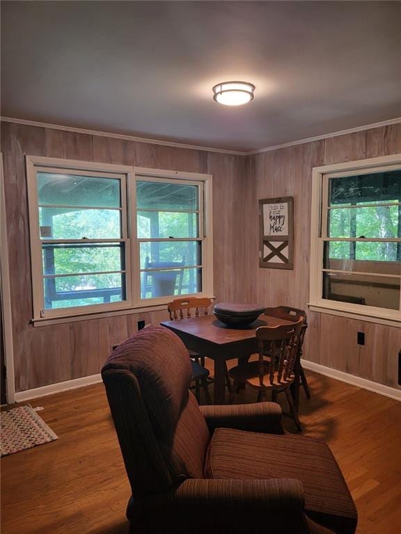 dining room with a wealth of natural light, crown molding, and wood finished floors