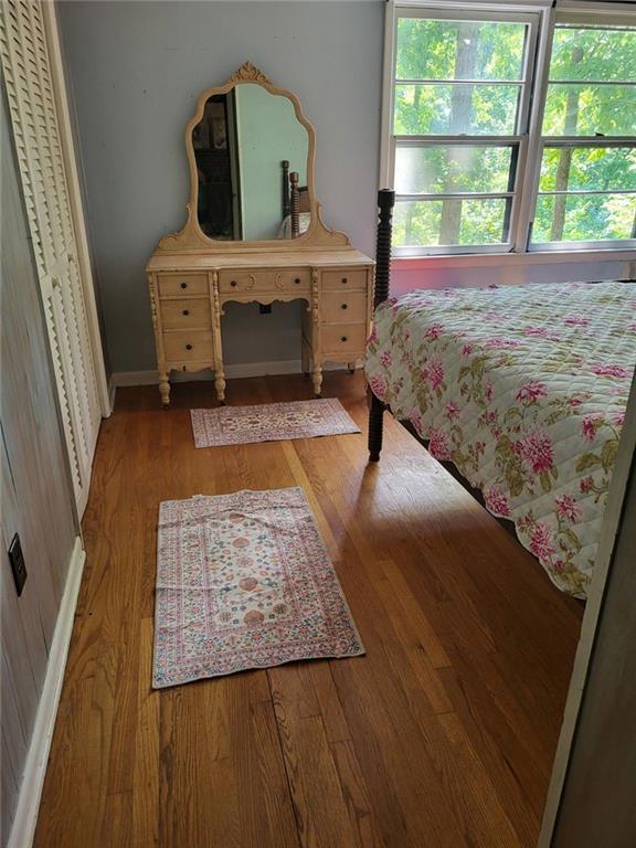 bedroom with light wood-type flooring and baseboards