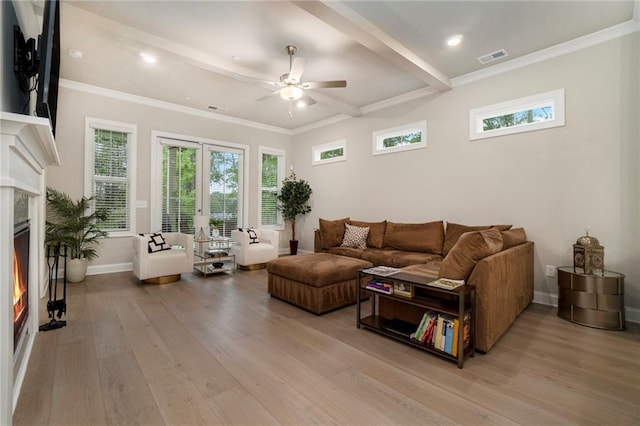 living room with a ceiling fan, baseboards, a high end fireplace, and light wood-type flooring