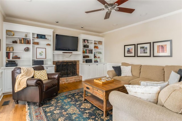 3157 Sawyer Ct NE, Marietta, GA 30066 - living area featuring crown molding, visible vents, a brick fireplace, wood finished floors, and a ceiling fan
