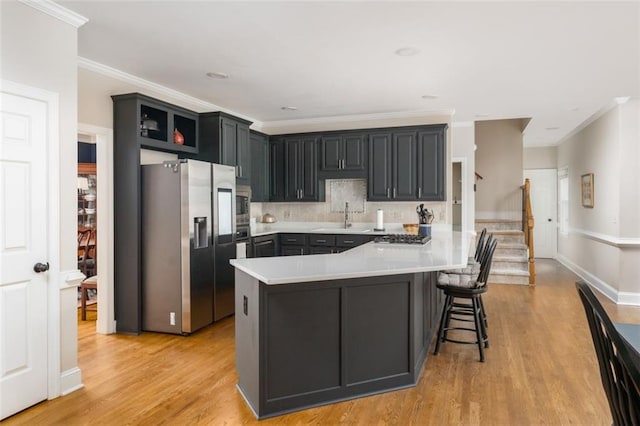3157 Sawyer Ct NE, Marietta, GA 30066 - kitchen featuring light wood-style flooring, stainless steel appliances, light countertops, a sink, and crown molding