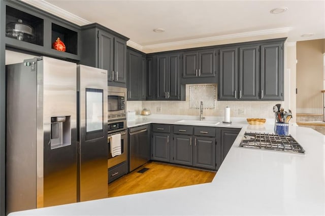 3157 Sawyer Ct NE, Marietta, GA 30066 - kitchen featuring light wood-style flooring, a sink, appliances with stainless steel finishes, light countertops, and backsplash