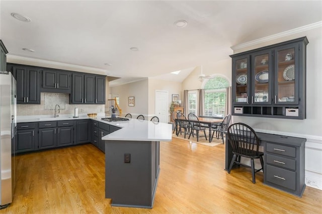 3157 Sawyer Ct NE, Marietta, GA 30066 - kitchen featuring a peninsula, light countertops, light wood-style flooring, and a sink