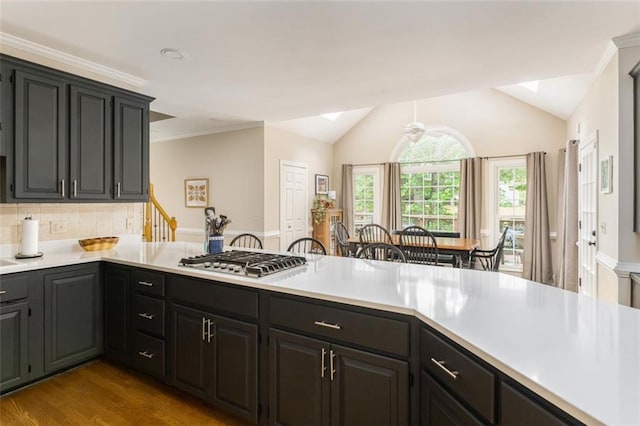 3157 Sawyer Ct NE, Marietta, GA 30066 - kitchen featuring stainless steel gas cooktop, light countertops, vaulted ceiling, dark wood-style flooring, and a peninsula