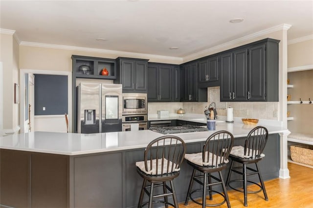 3157 Sawyer Ct NE, Marietta, GA 30066 - kitchen featuring stainless steel appliances, light countertops, ornamental molding, a sink, and a peninsula