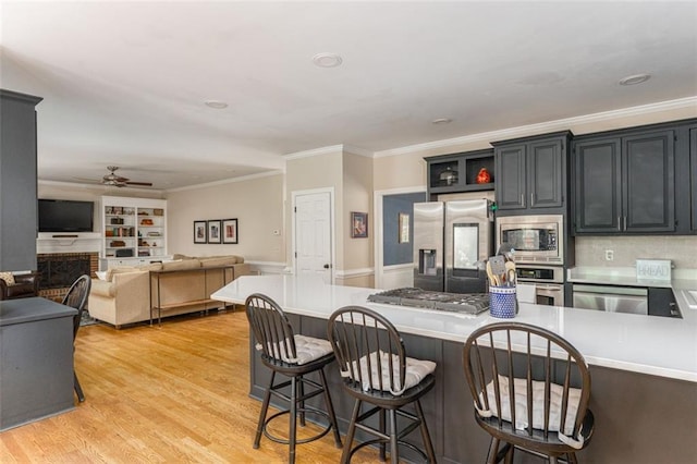 3157 Sawyer Ct NE, Marietta, GA 30066 - kitchen featuring stainless steel appliances, light countertops, ceiling fan, a peninsula, and crown molding
