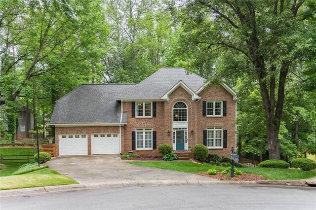 3157 Sawyer Ct NE, Marietta, GA 30066 - colonial inspired home with concrete driveway, an attached garage, fence, brick siding, and a front lawn