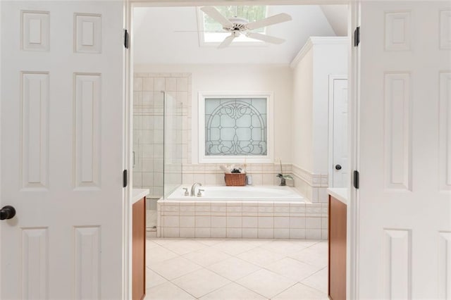 3157 Sawyer Ct NE, Marietta, GA 30066 - bathroom with lofted ceiling, ceiling fan, tile patterned floors, a garden tub, and tiled shower