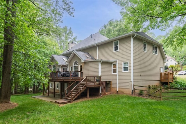 3157 Sawyer Ct NE, Marietta, GA 30066 - rear view of house featuring a deck, a chimney, stairway, fence, and a lawn
