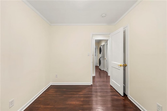 2903 Akron St, East Point, GA 30344 - spare room featuring stacked washer and clothes dryer, a smoke detector, ornamental molding, and wood finished floors