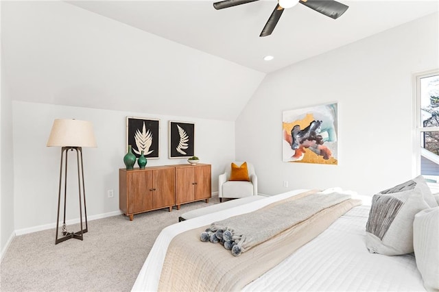 bedroom with ceiling fan, lofted ceiling, and light carpet