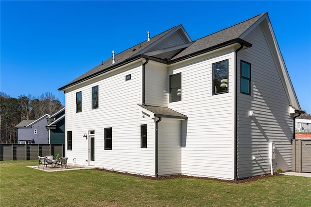 back of house with a lawn and a patio area