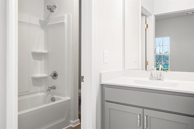 full bathroom featuring toilet, vanity, and bathing tub / shower combination