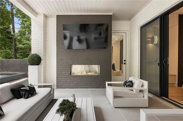 interior space with light tile patterned flooring, brick wall, and a fireplace