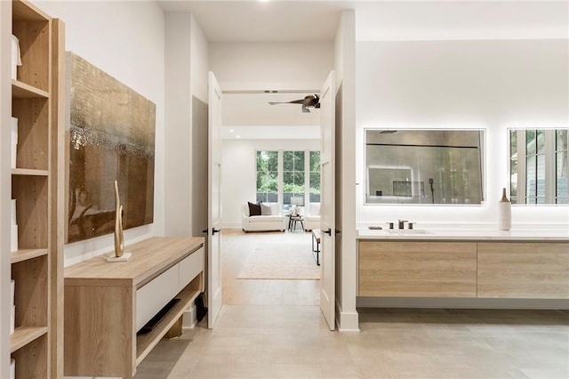 bathroom with ceiling fan and vanity