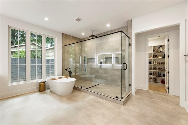 bathroom with separate shower and tub