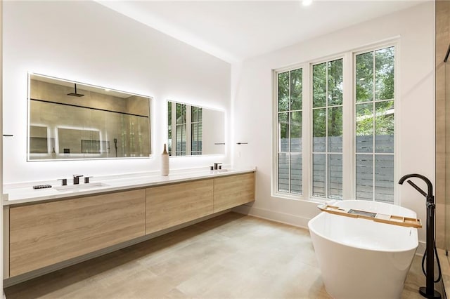 bathroom featuring a tub to relax in and vanity